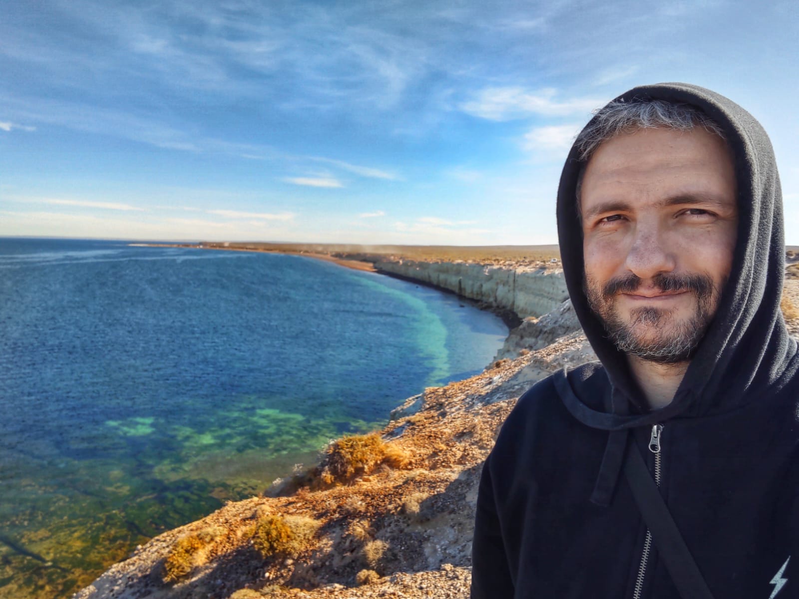 Nelson E. Bolivar by a turquoise bay on the coast