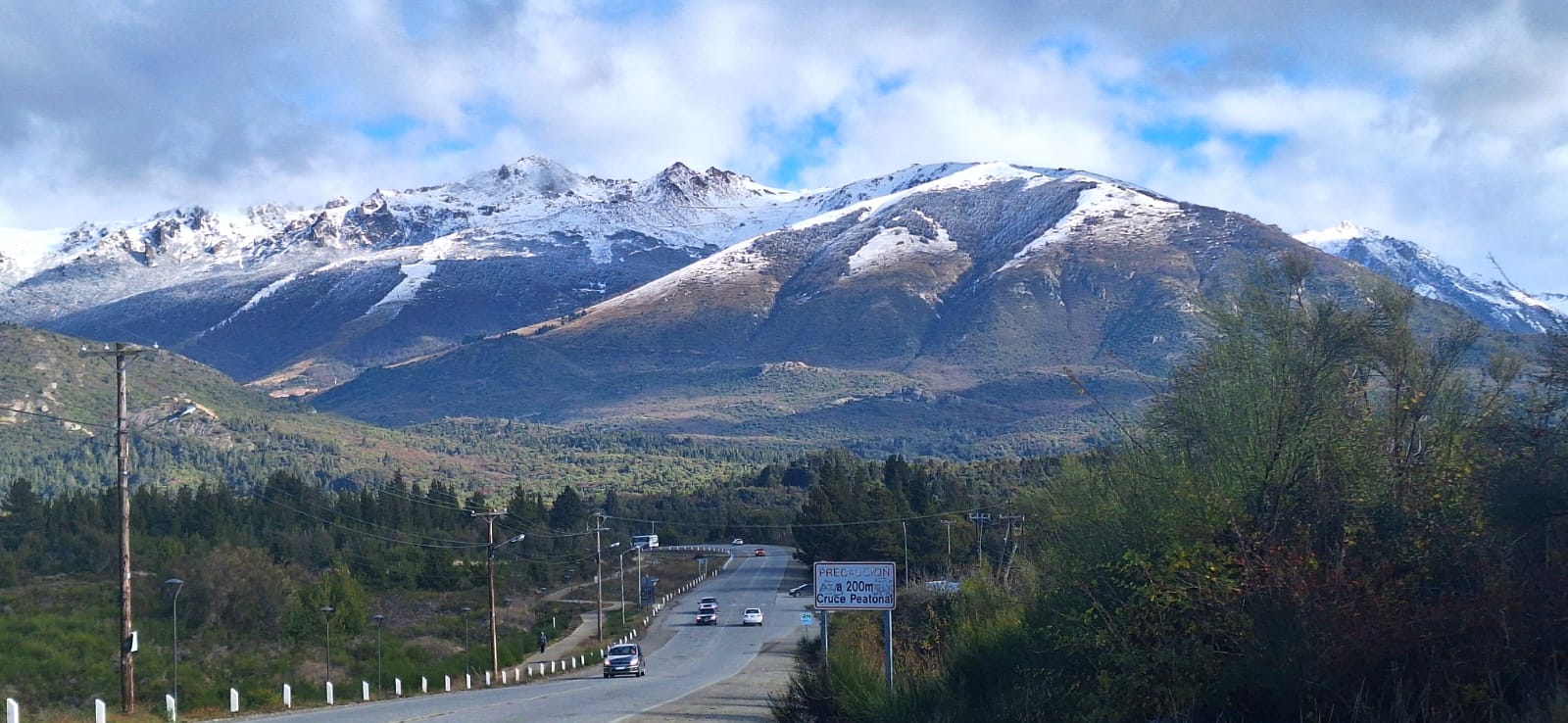 Mountain landscape with a winding road under a dramatic sky